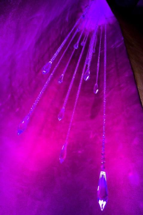 Crystal droplets suspended in violet light in the stairwell