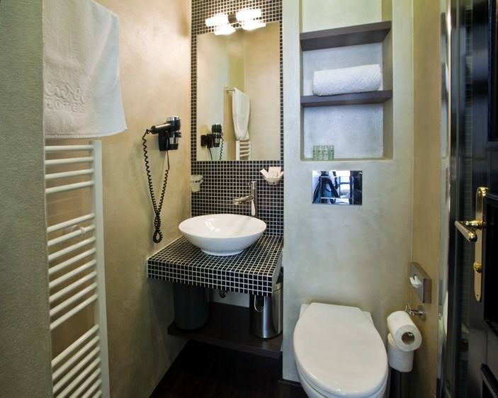 Onyx room bathroom with black mosaic, vessel basin and heated towel rail