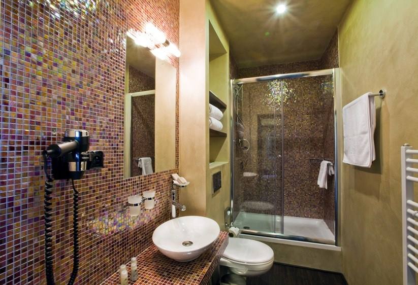 Ruby room bathroom with iridescent mosaic, vessel basin and shower
