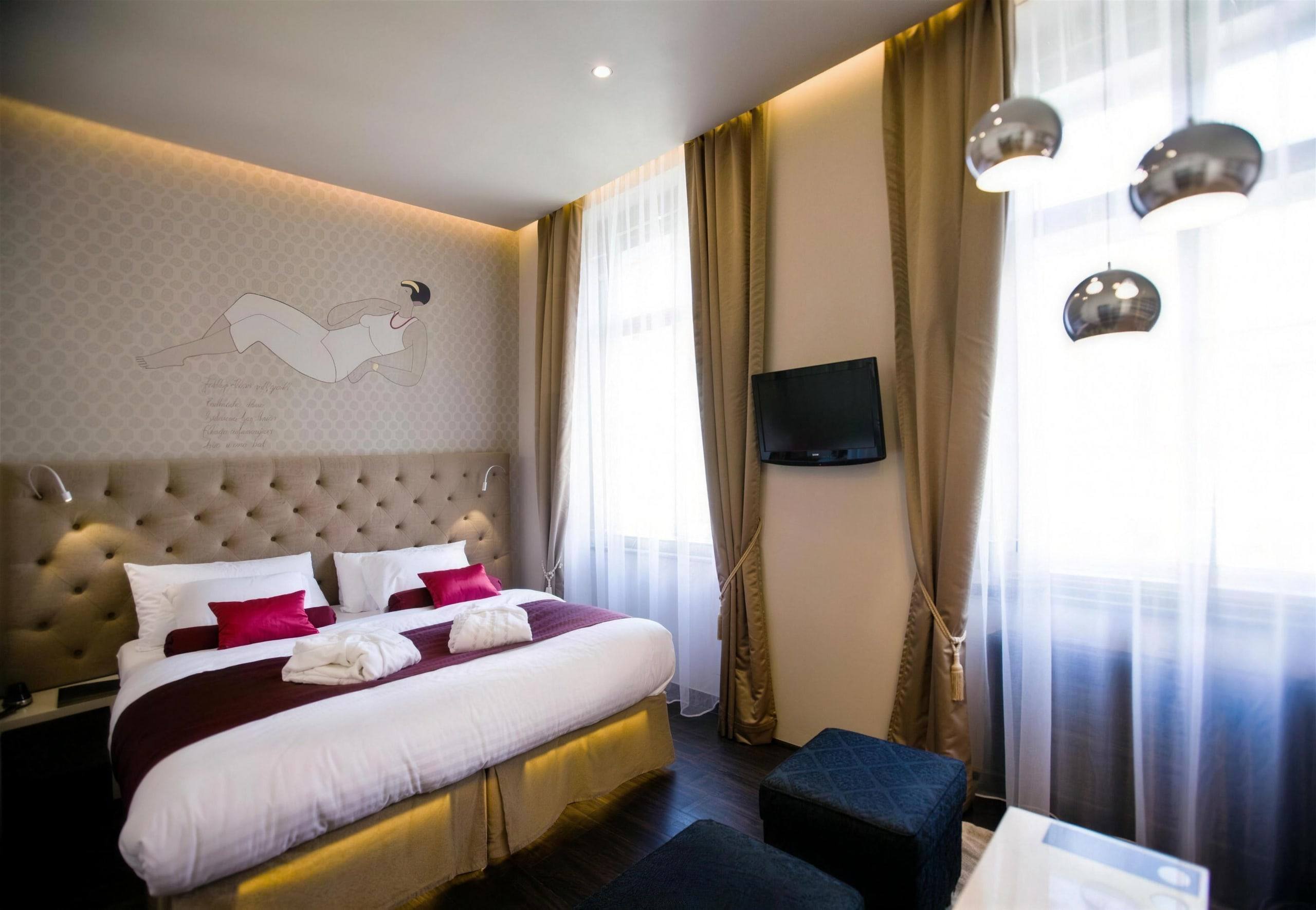 Ruby room with double bed, wine-red runner, bathrobes and tall windows
