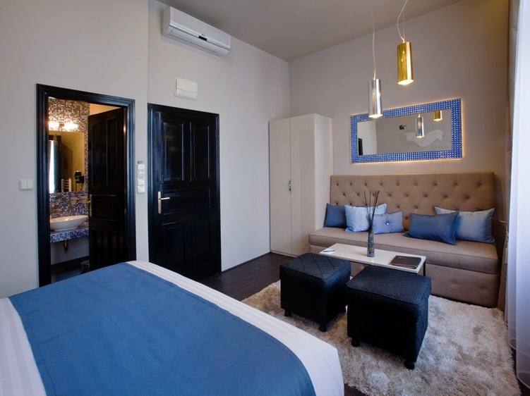 Sitting area in the Sapphire room with sofa, blue cushions and a blue-crystal framed mirror