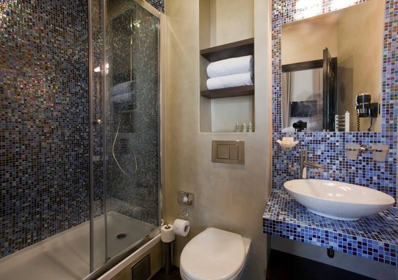 Sapphire room bathroom with blue-violet mosaic, vessel basin and shower